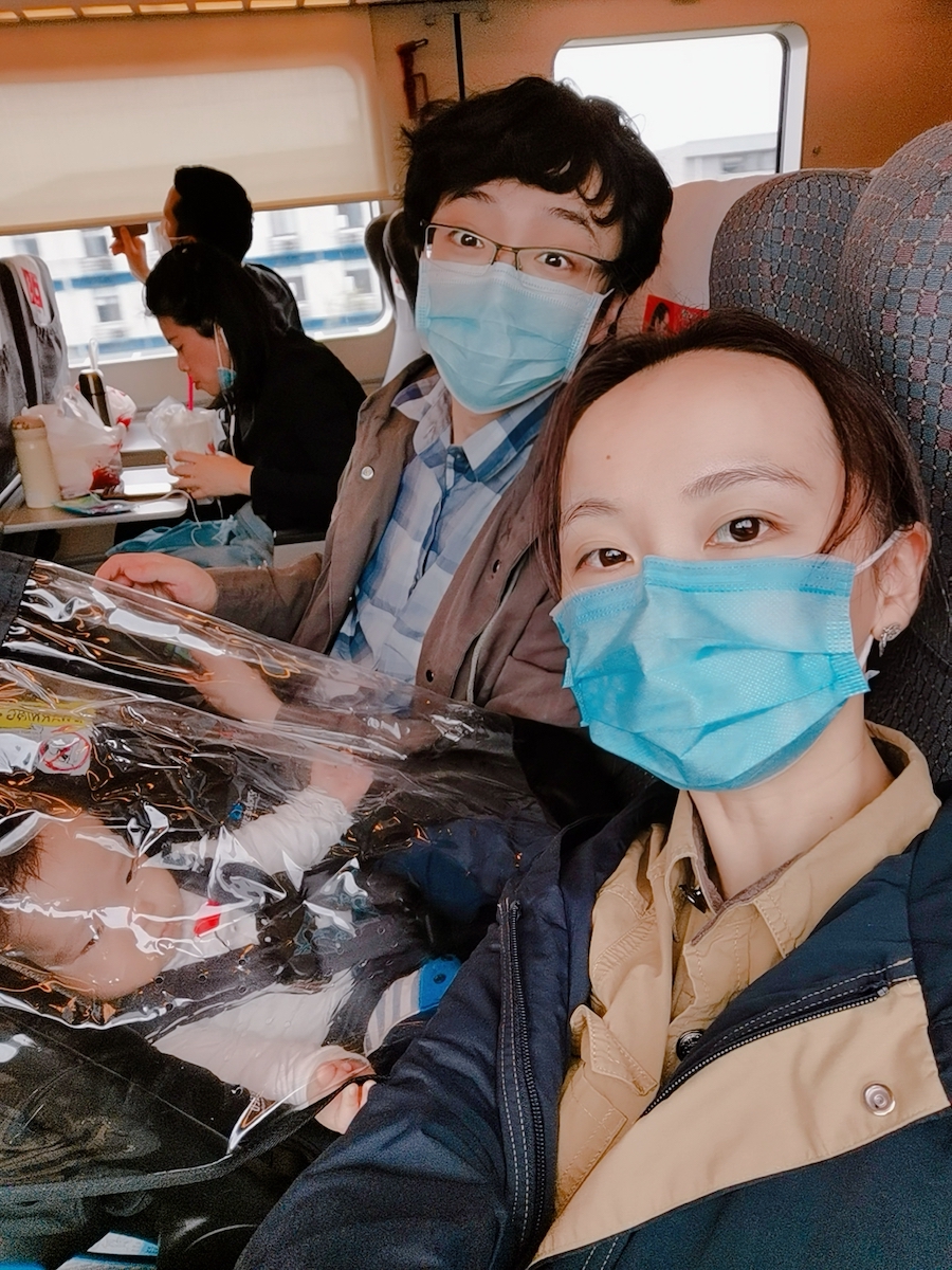 A photo of Coaca Bean riding a train with his parents.