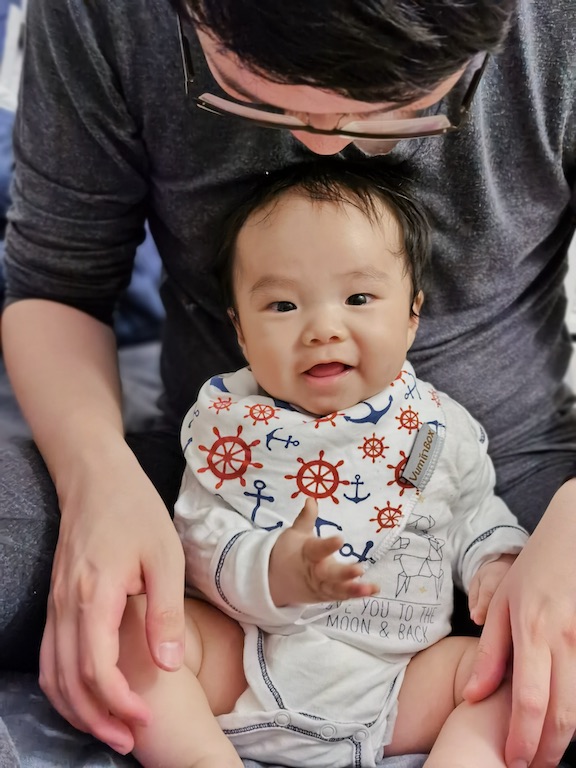 A photo of Cocoa Bean sitting by his daddy.