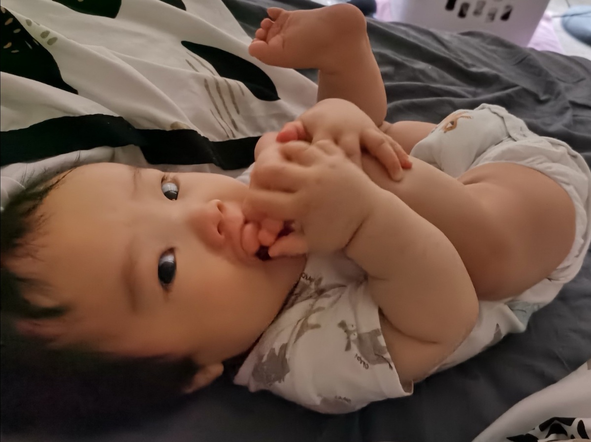 A photo of Coaca Bean chewing on his toes