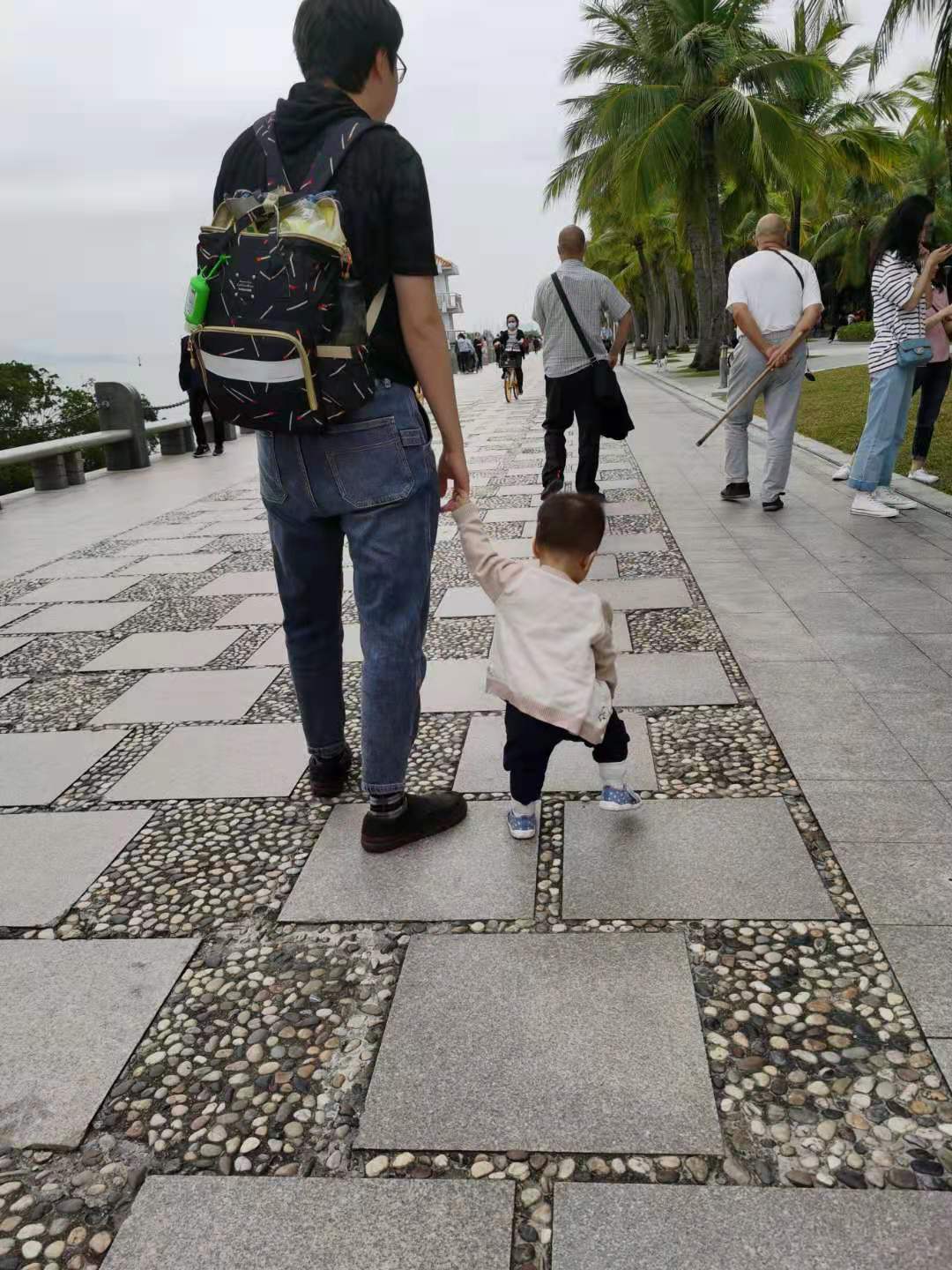 Coaca Bean is taking a stroll in a park.